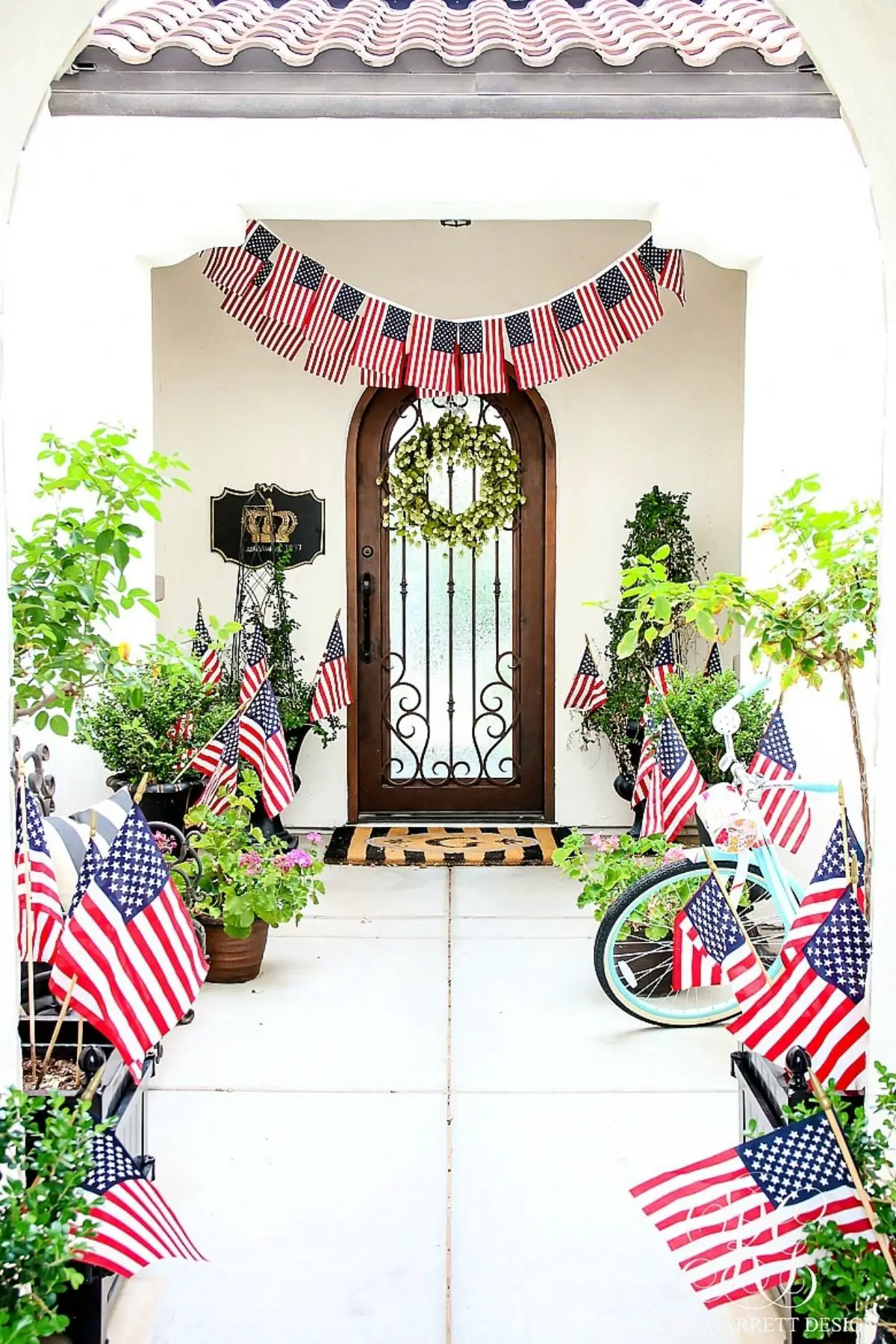 4th of July porch with a path of american flags and a flag banner over the door