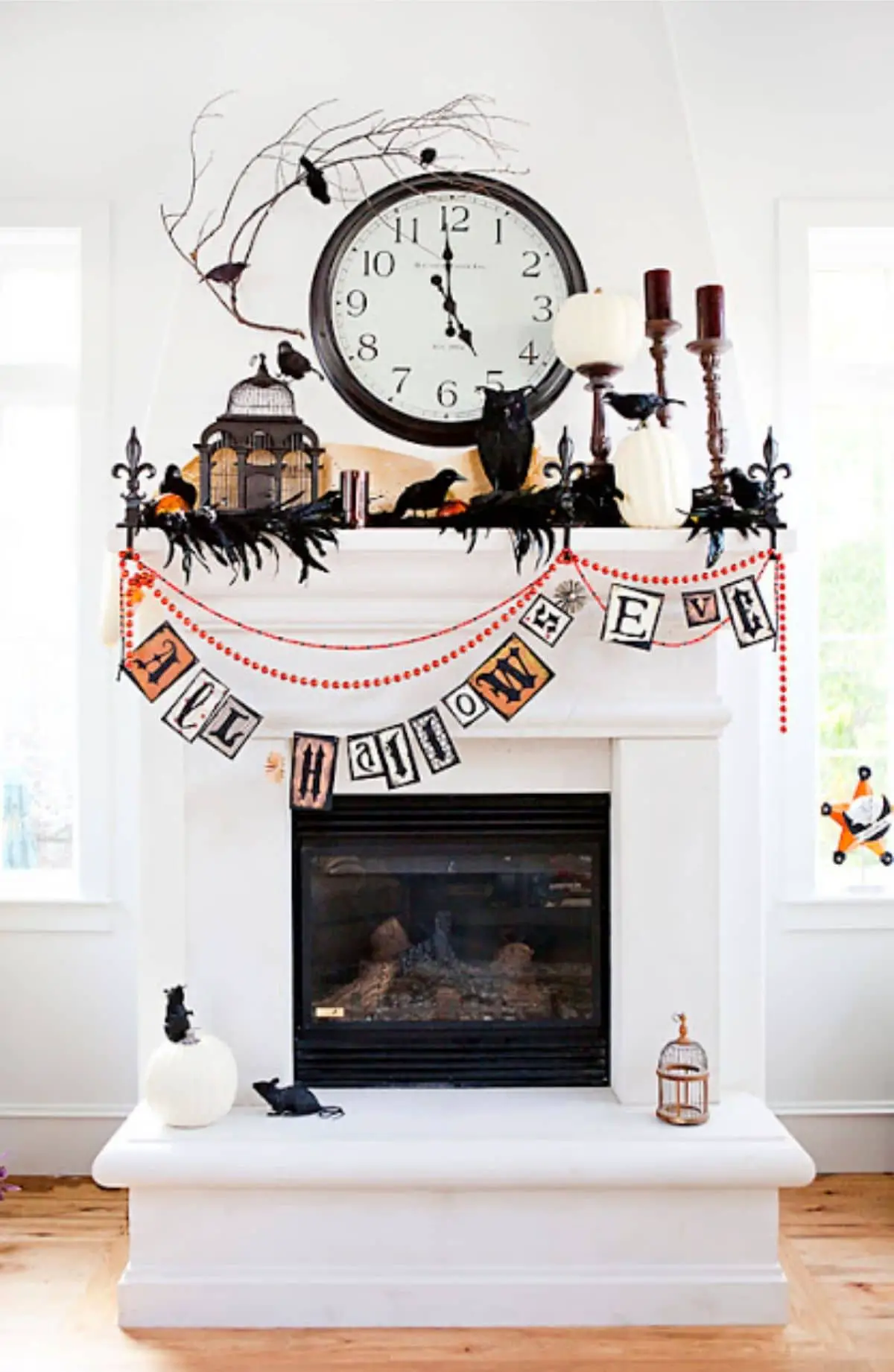 mantel that says all hallow's eve and decorated with black birds and owl