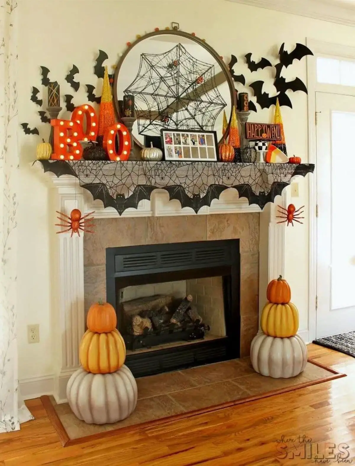 mantel with colorful pumpkins, BOO letters, bats, and spiderweb