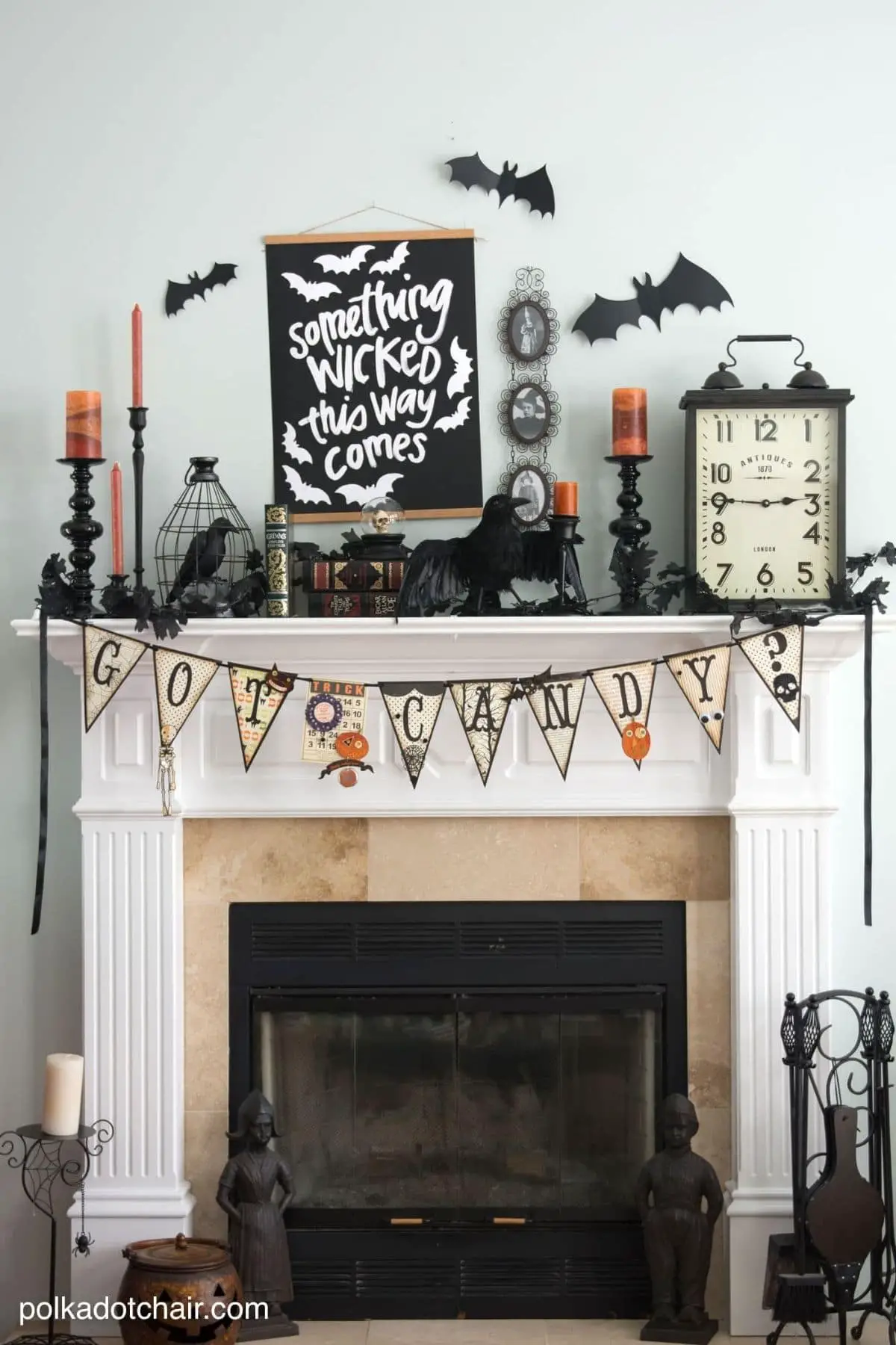 mantel with a banner that spells Got Candy and a letterboard that says Something Wicket This Way Comes