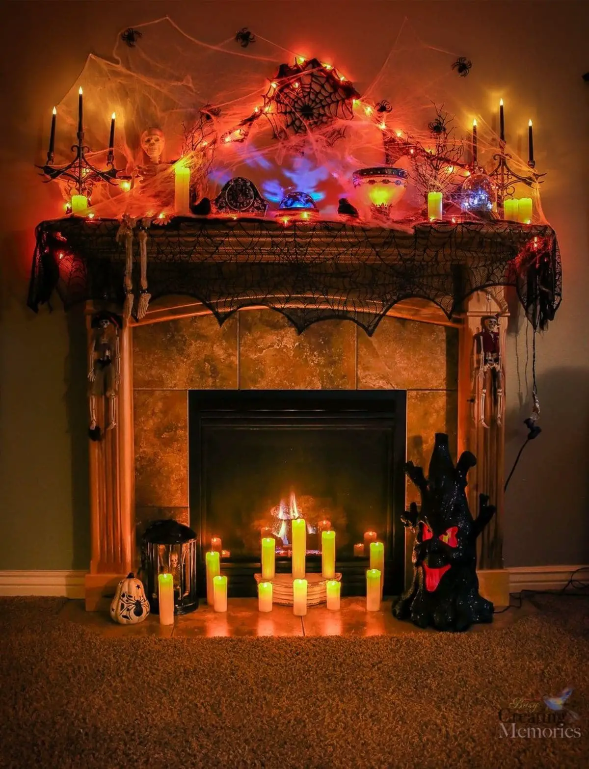 mantel all lit up with regular candles and orange lights