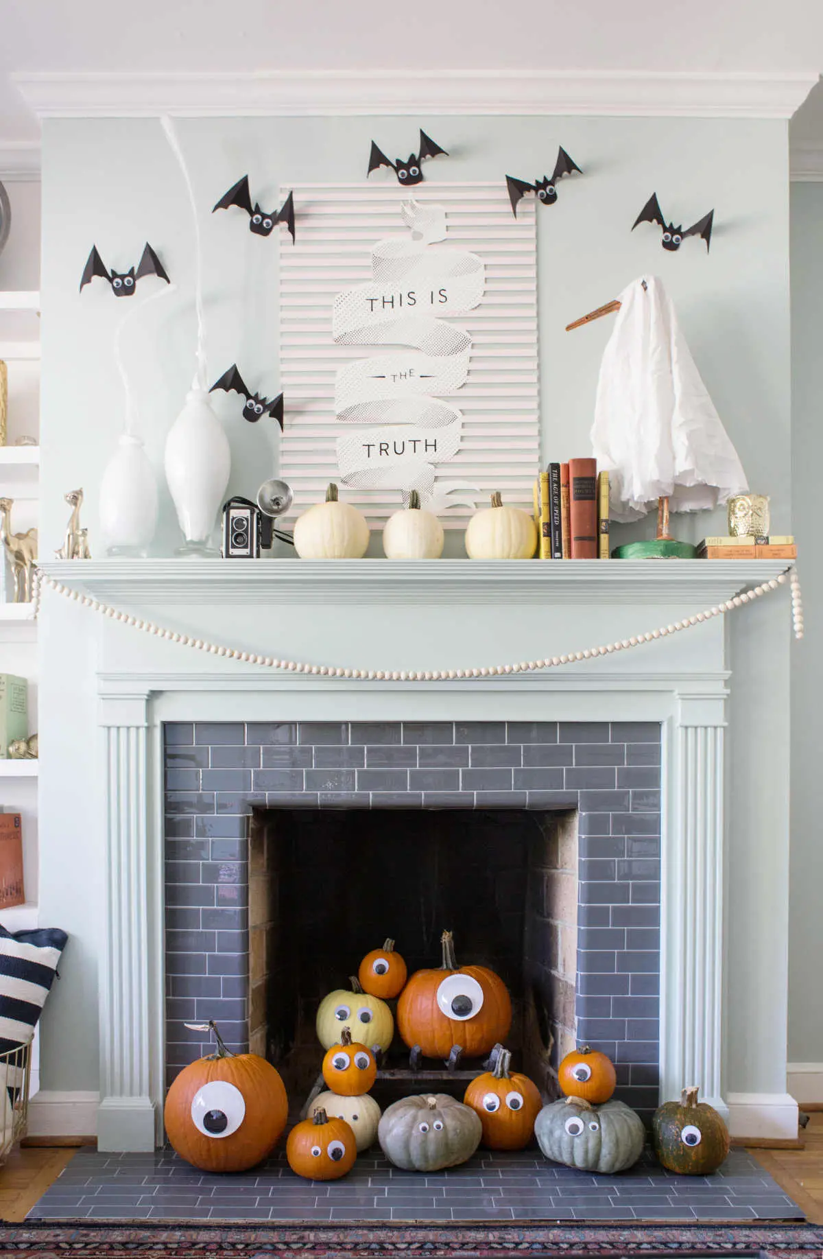 mantel with bats, ghost, and white pumpins