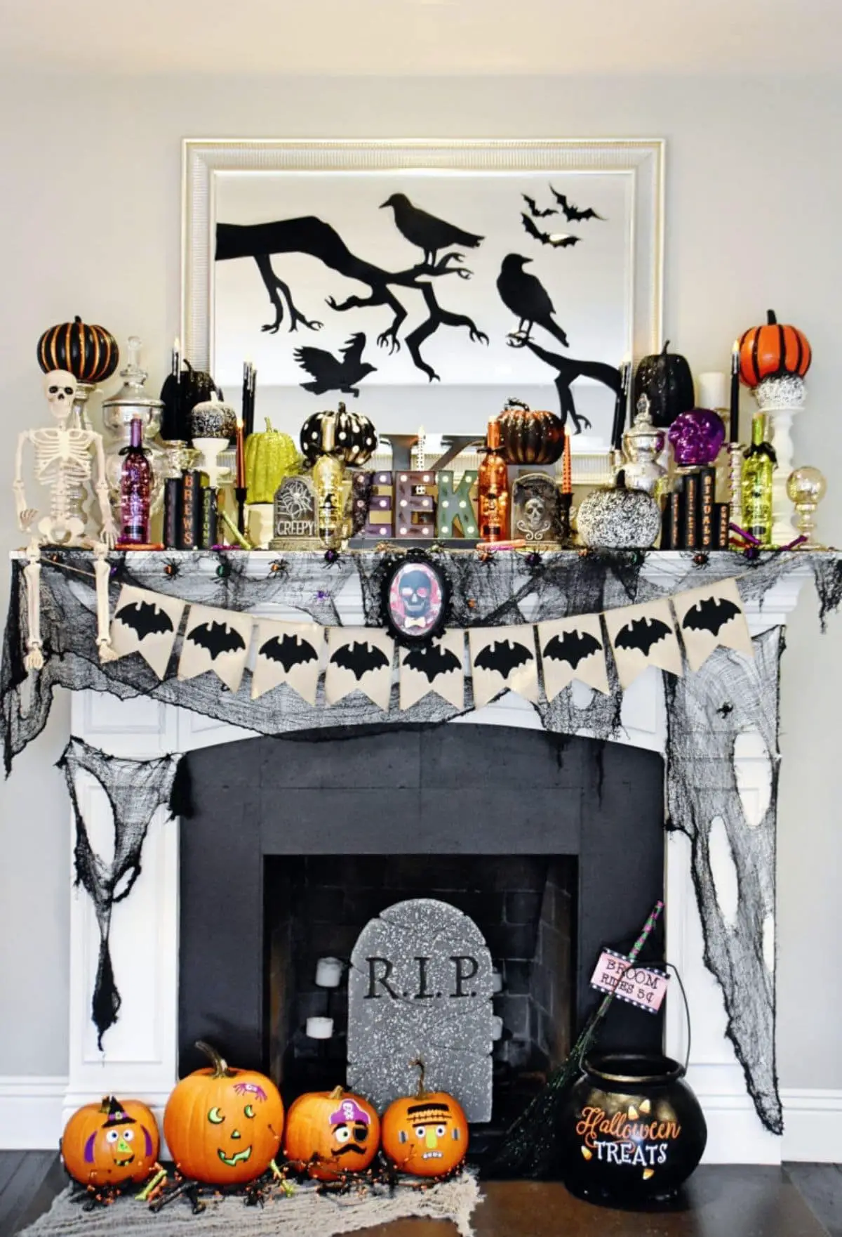 mantel with RIP headstone and lots of pumpkins