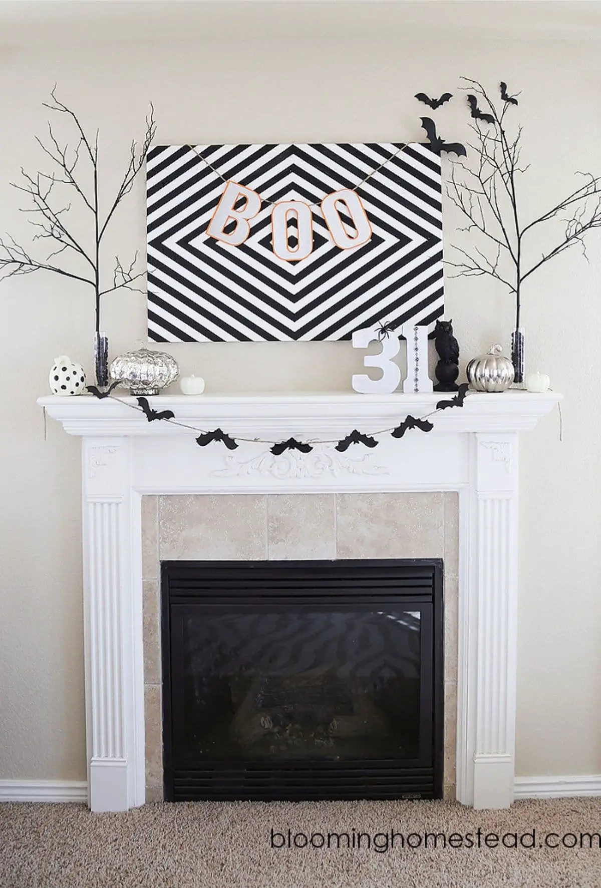 mantel with bat banner, trees, 31, and picture that says BOO
