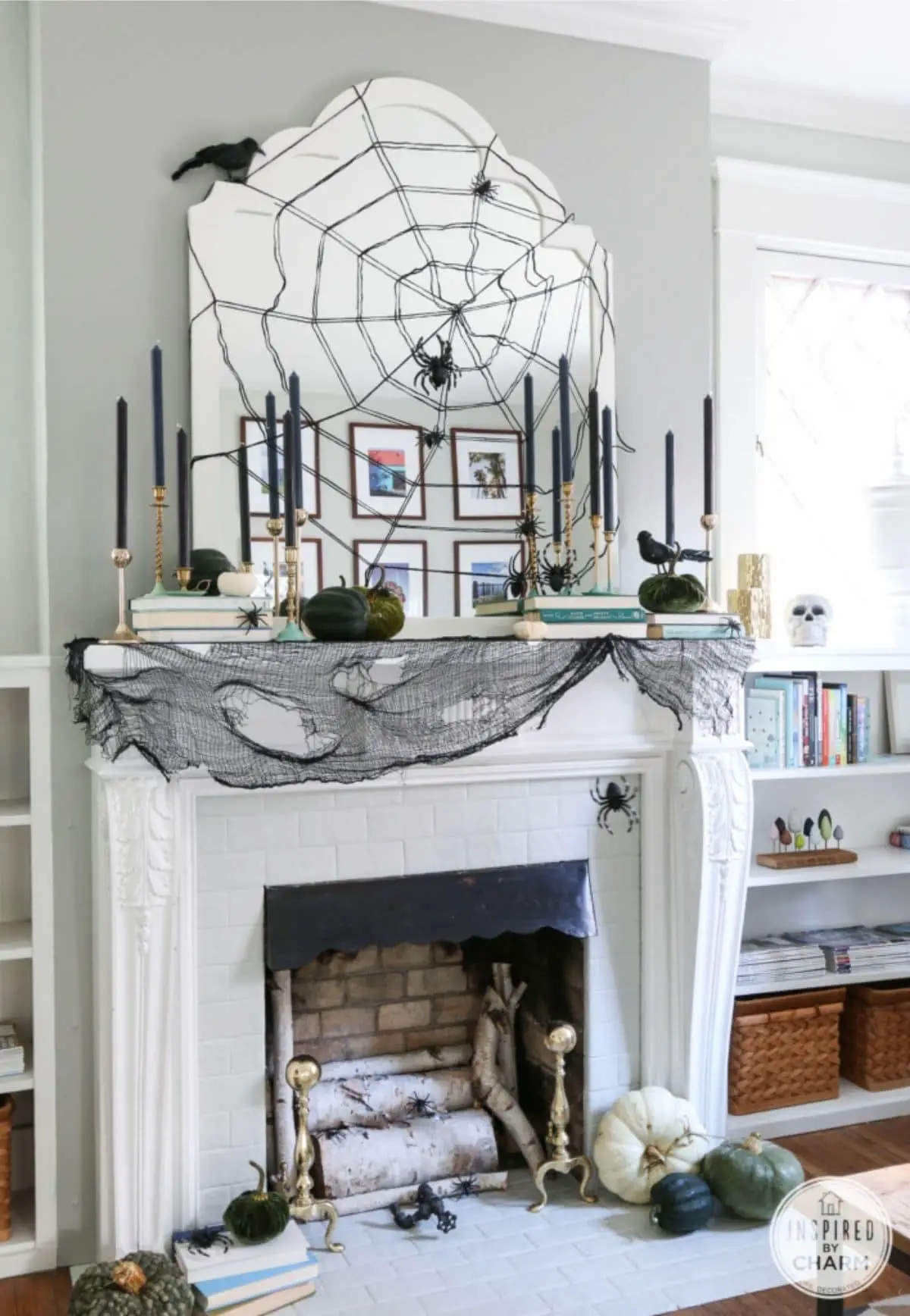 mantel with black spiders, black candles, and a big spiderweb