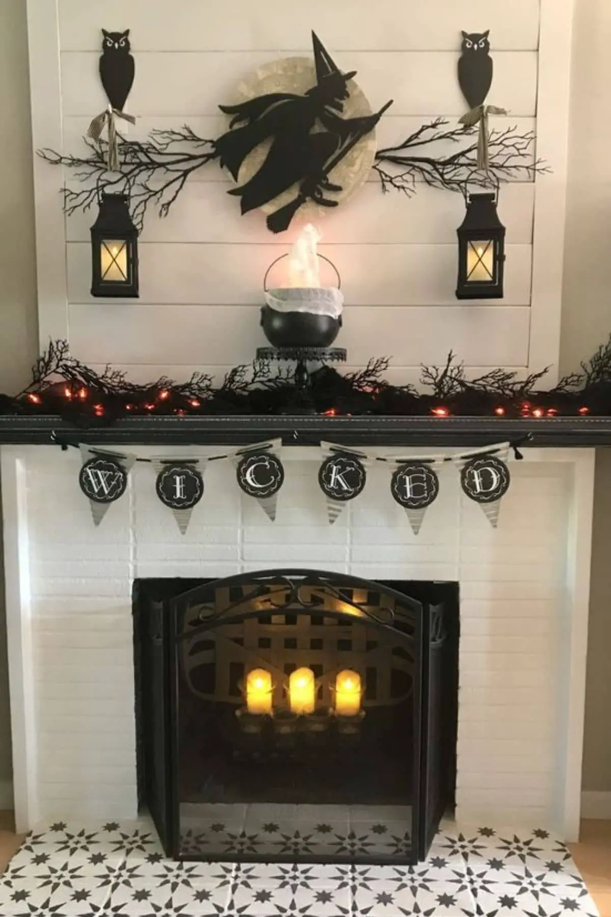 mantel with black owls, lanterns, cauldron, and banner that says Wicked