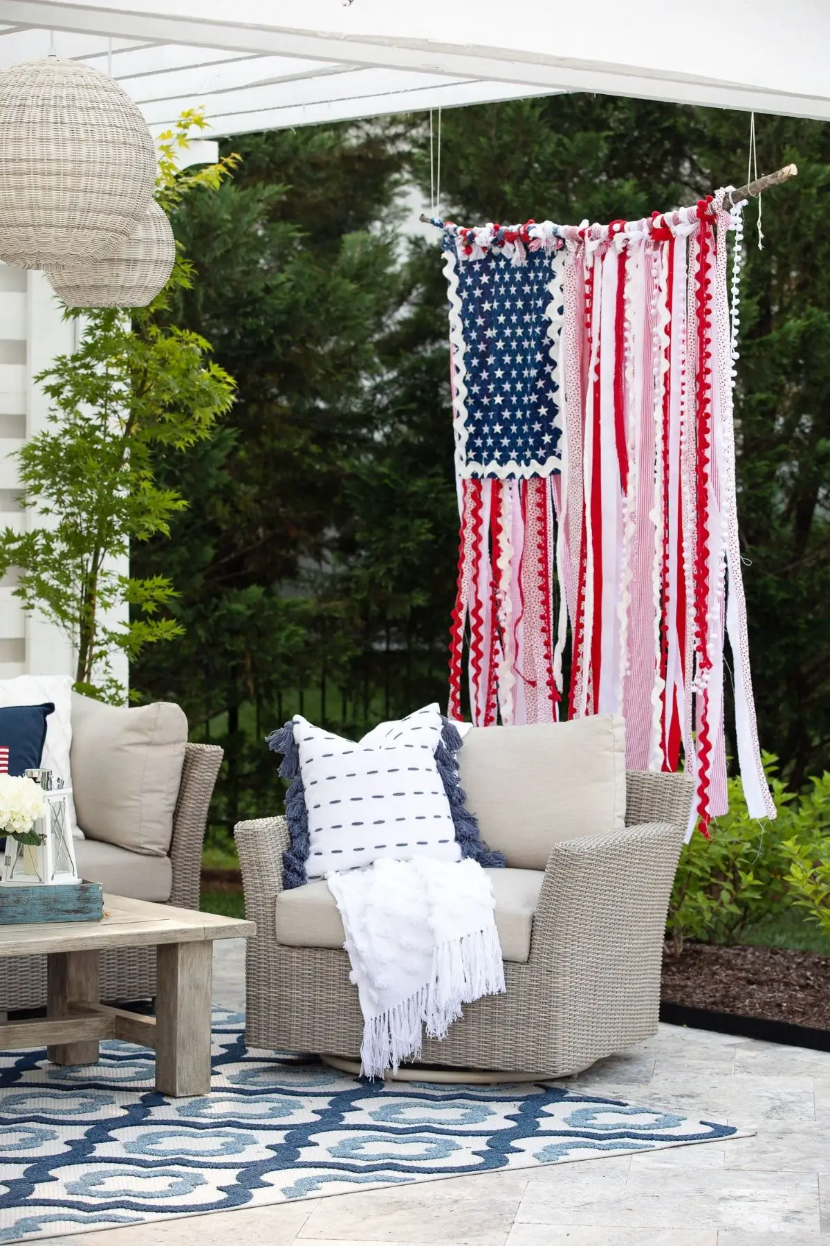 hanging american flag made with rags next to porch furniture