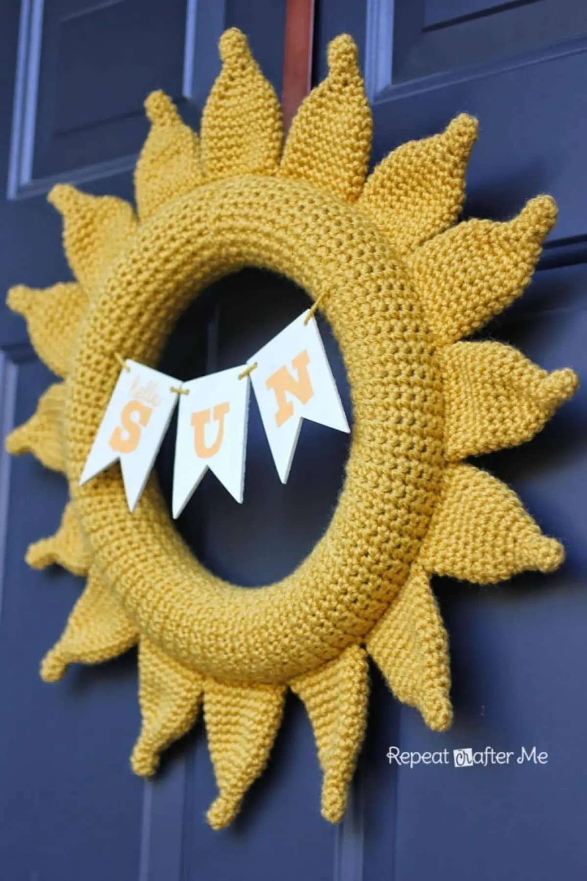yellow crochet sun wreath craft that says sun hanging from a banner in the center of the sun