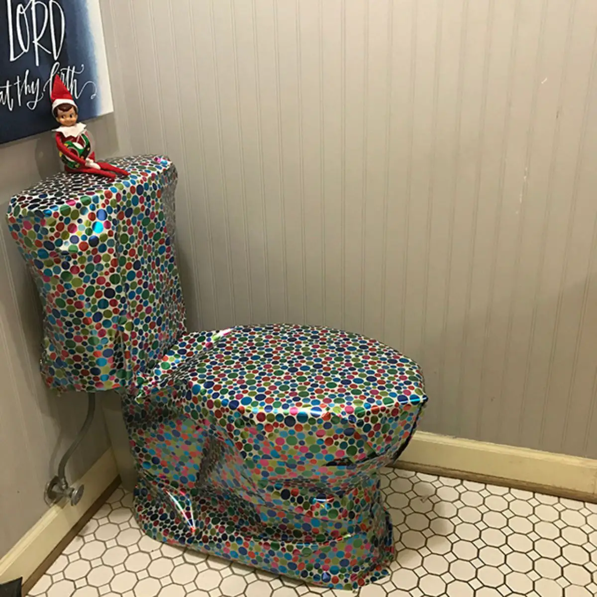 Elf on the shelf wrapped a toilet