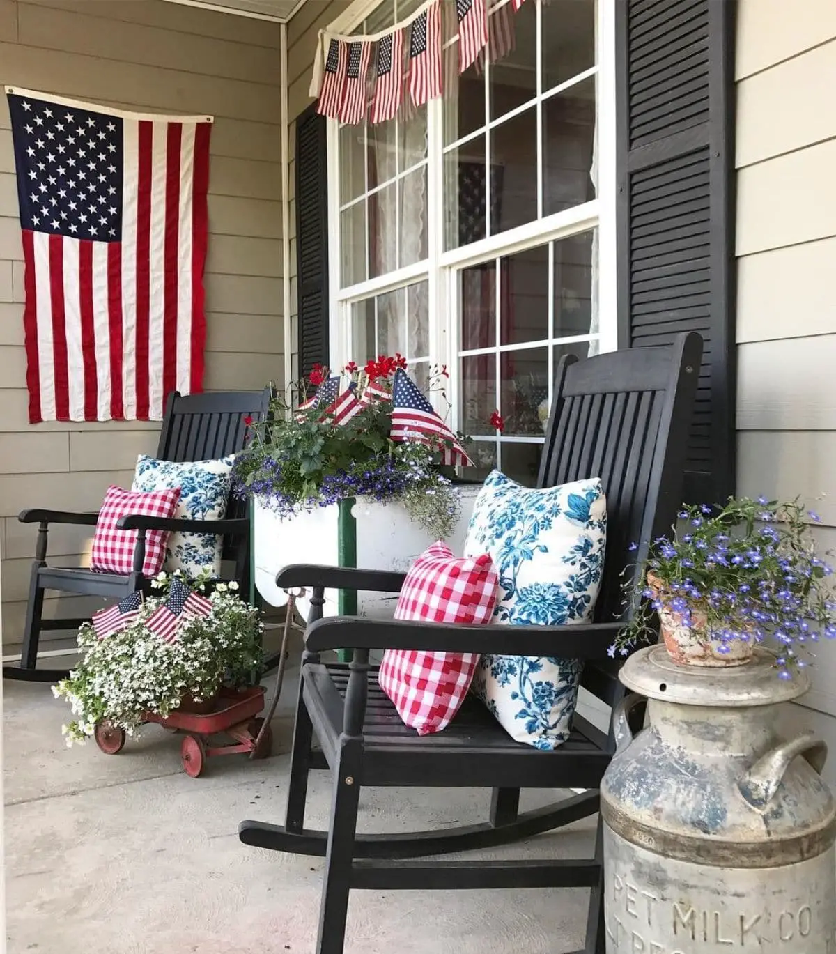 porch with black rocking chairs, festive pillows and flags