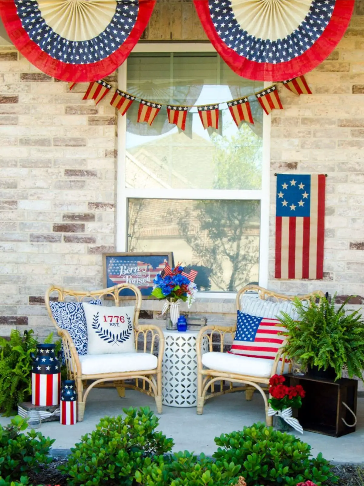 porch with wicker chairs, patriotic throw pillows and flags