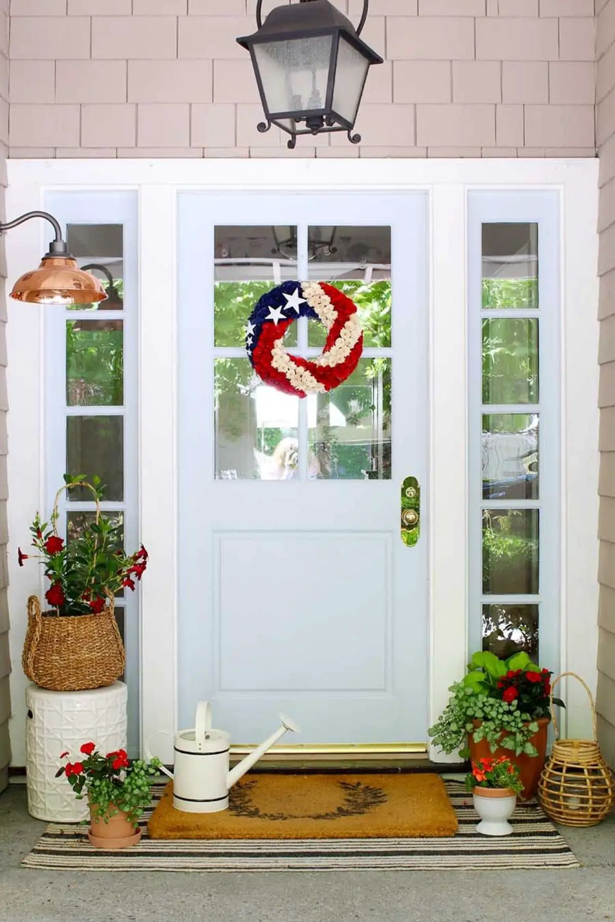 porch with red flowers and 4th of july wreath